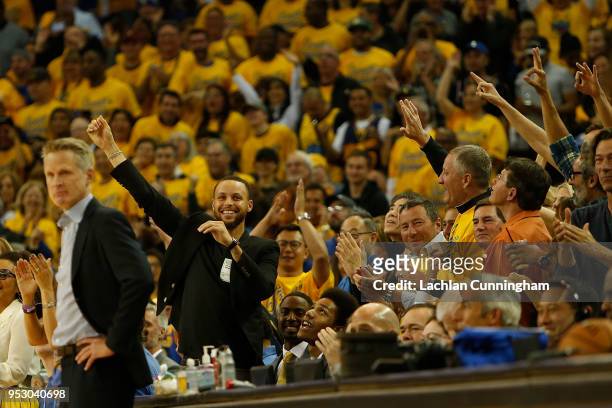 Stephen Curry of the Golden State Warriors reacts to a basket made by teammate Klay Thompson during Game One of the Western Conference Semifinals...