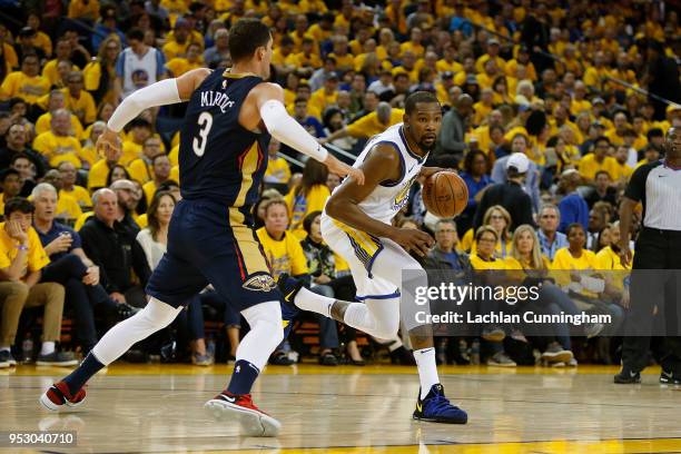 Kevin Durant of the Golden State Warriors is guarded by Nikola Mirotic of the New Orleans Pelicans during Game One of the Western Conference...