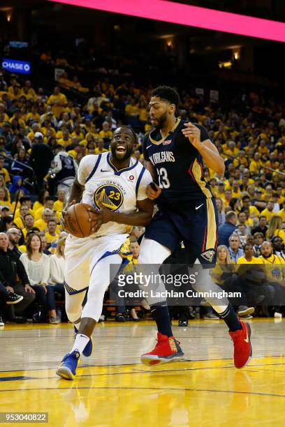 Draymond Green of the Golden State Warriors drives to the basket against Anthony Davis of the New Orleans Pelicans during Game One of the Western...