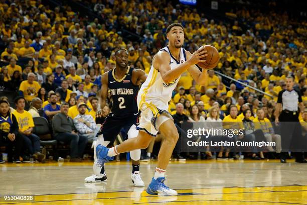 Klay Thompson of the Golden State Warriors drives to the basket past Ian Clark of the New Orleans Pelicans during Game One of the Western Conference...