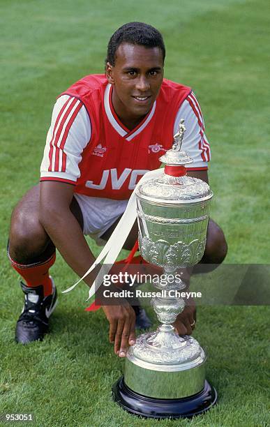 Portrait of David Rocastle of Arsenal posing with the Littlewoods Cup which Arsenal had won the season before during a photo-shoot held at Highbury,...