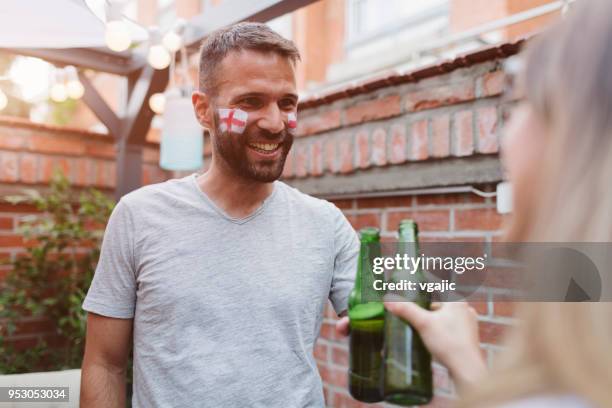 friends watching soccer game on big screen in backyard - england flag stock pictures, royalty-free photos & images