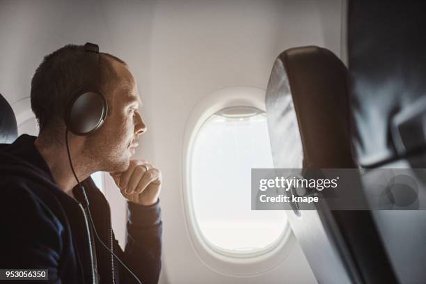 traveling man on airplane flying - boom for real stock pictures, royalty-free photos & images