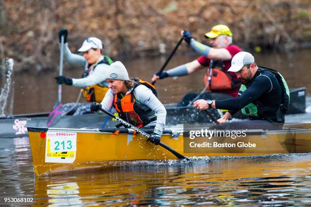 Participants take part in 36th Run of the Charles paddle race along the Charles River in Dedham, MA on April 29, 2018.