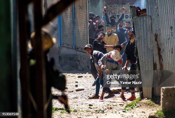 Kashmiri Muslim protesters throw stones at Indian armed forces near the site of gun battle between Indian armed forces and Kashmiri rebels, on April...