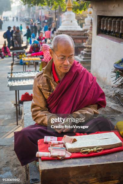 kathmandu buddhist monk offering prayers at swayambhunath monkey temple nepal - thamel stock pictures, royalty-free photos & images