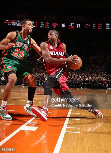 Dwyane Wade of the Miami Heat drives against Jared Jeffries of the New York Knicks on December 25, 2009 at Madison Square Garden in New York City....