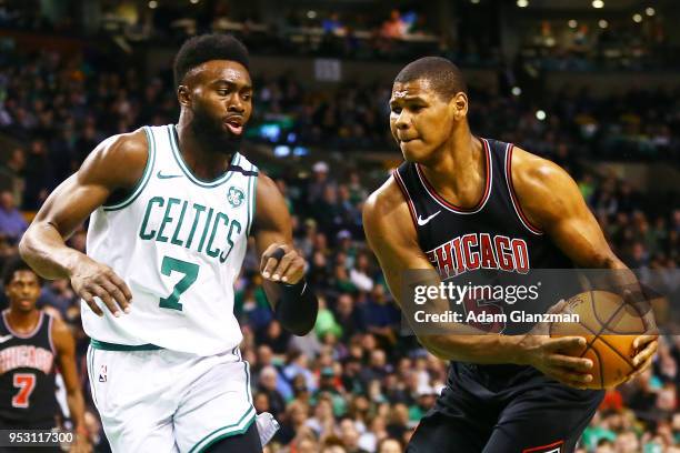 Cristiano Felicio of the Chicago Bulls dribbles past Jaylen Brown of the Boston Celtics during a game at TD Garden on April 6, 2018 in Boston,...