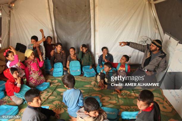 Picture taken on April 30, 2018 in a camp for displaced Syrians from villages and towns around Abu Duhur on the eastern edge of Idlib province, shows...