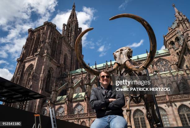 French artist and architect Jacques Rival poses in front of a mammoth skeleton for his installation 'Mammuthus Volantes' in front of Strasbourg...