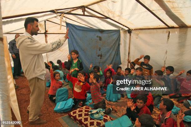 Picture taken on April 30, 2018 in a camp for displaced Syrians from villages and towns around Abu Duhur on the eastern edge of Idlib province, shows...