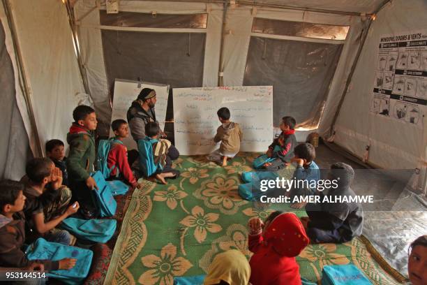 Picture taken on April 30, 2018 in a camp for displaced Syrians from villages and towns around Abu Duhur on the eastern edge of Idlib province, shows...