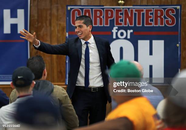 Daniel Koh, a candidate for congress in the third congressional district, waves to members of the New England Regional Council of Carpenters as he...