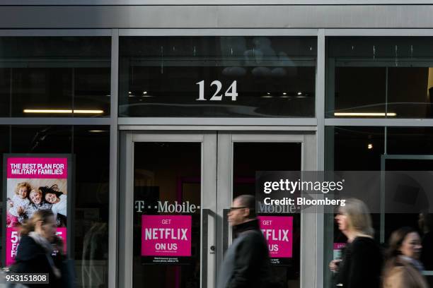 Pedestrians pass in front of a T-Mobile US Inc. Store in New York, U.S. On Monday, April 30, 2018. Sprint Corp. Suffered its worst stock decline in...