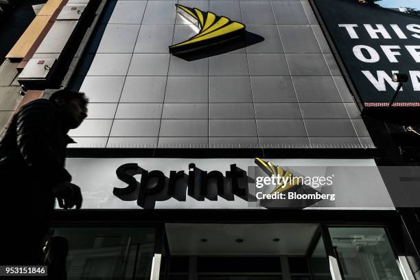 Pedestrians pass in front of a Sprint Corp. Store in New York, U.S. On Monday, April 30, 2018. Sprint Corp. Suffered its worst stock decline in...
