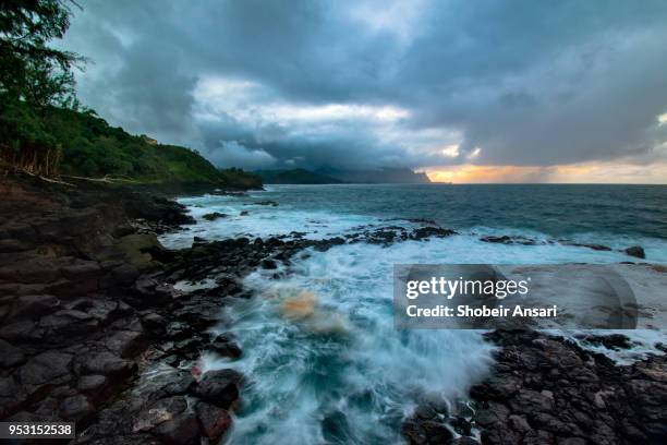 stormy day in princeville shore, kauai, hawaii - princeville stock pictures, royalty-free photos & images