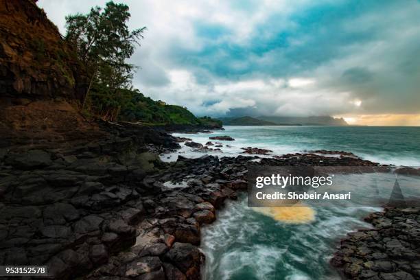 lava rocks at princeville shoreline, kauai, hawaii - princeville stock pictures, royalty-free photos & images