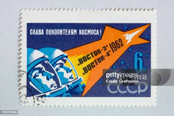 close up of post stamp showing two astronauts in space - soviet union stock illustrations