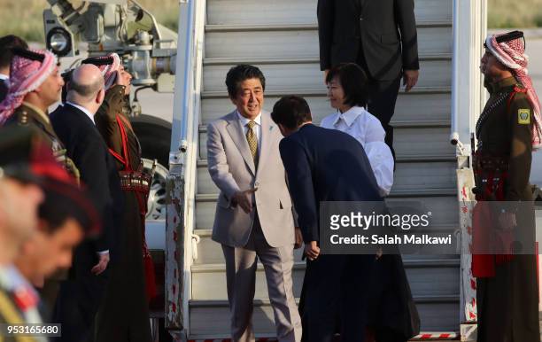 Japanese Prime Minister Shinzo Abe and wife Akie Abe are greeted as they arrive at Marka international airport on April 30, 2018 in Amman, Jordan....