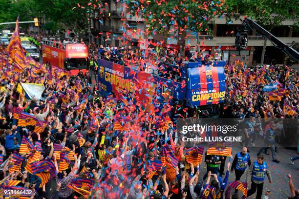 Barcelona players and staff parade with open-top buses to celebrate their 25th La Liga title in Barcelona on April 30, 2018. - Barcelona won their...