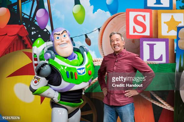 In this handout photo provided by Disney Parks, Tim Allen strikes a pose with Buzz Lightyear after taping an interview for Toy Story Land-exclusive...