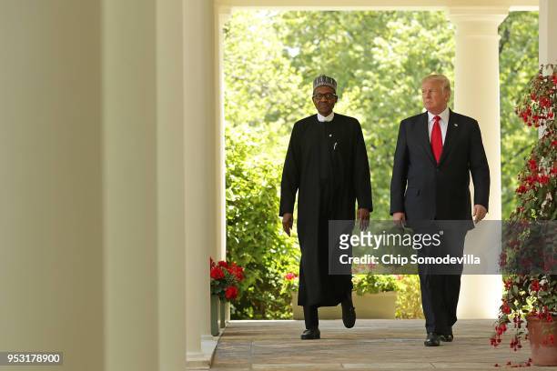 President Donald Trump and Nigerian President Muhammadu Buhari walk into the Rose Garden for a joint press conference at the White House April 30,...