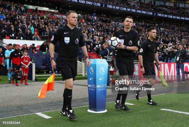 The match referee, Michael Oliver picks up the ball during the Premier League match between Tottenham Hotspur and Watford at Wembley Stadium on April...