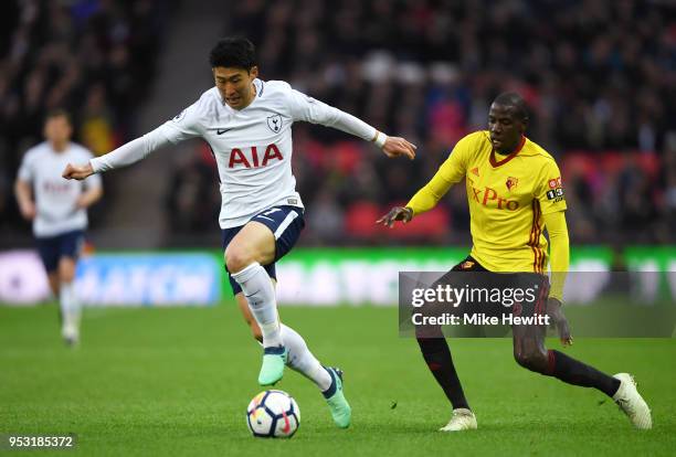 Heung-Min Son of Tottenham Hotspur and Abdoulaye Doucoure of Watford battle for the ball during the Premier League match between Tottenham Hotspur...