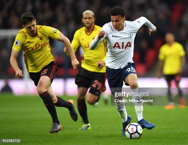 Craig Cathcart of Watford puts pressure on Dele Alli of Tottenham Hotspur during the Premier League match between Tottenham Hotspur and Watford at...