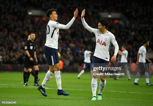 Dele Alli of Tottenham Hotspur celebrates scoring his side's first goal with team mate Heung-Min Son during the Premier League match between...