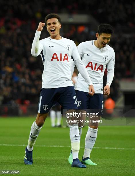 Dele Alli of Tottenham Hotspur celebrates scoring his side's first goal with team mate Heung-Min Son during the Premier League match between...