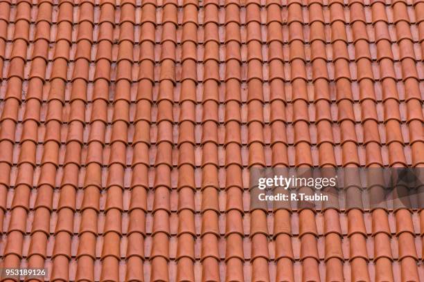 closeup of the red clay roof tiles as a background - roof tile stock-fotos und bilder