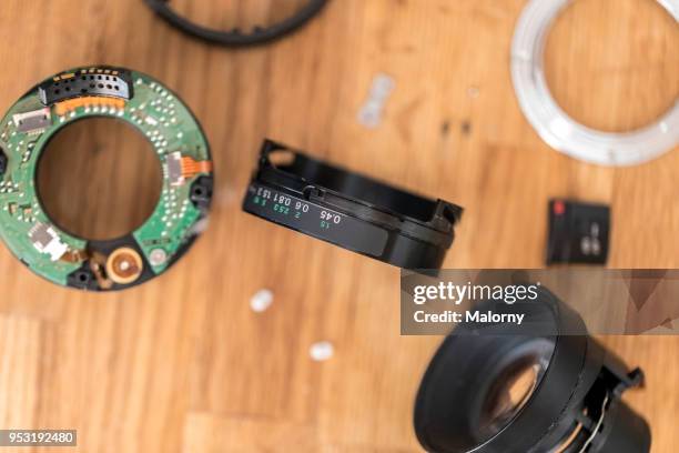 lens of a camera decomposed in its individual parts. - lens flair stock-fotos und bilder