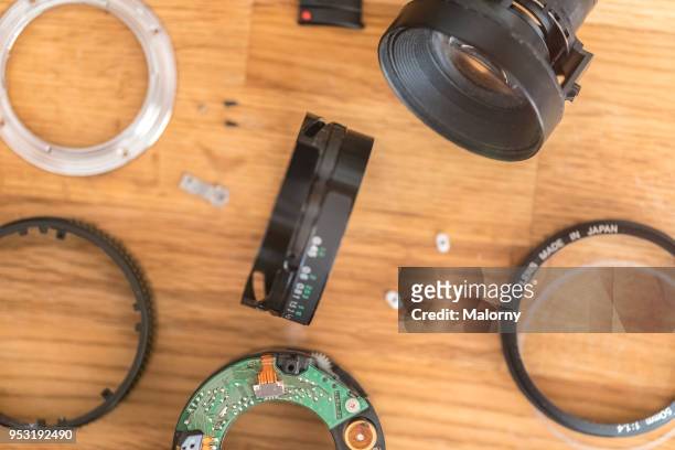 lens of a camera decomposed in its individual parts. - lens flair stock-fotos und bilder