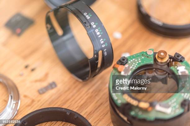 lens of a camera decomposed in its individual parts. - lens flair stock-fotos und bilder