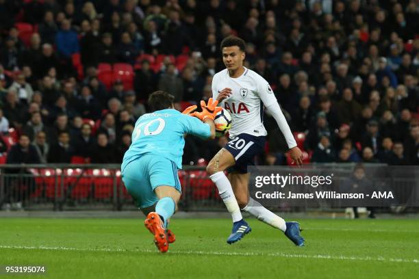 Orestis Karnezis of Watford reaches a cross before Dele Alli of Tottenham during the Premier League match between Tottenham Hotspur and Watford at...