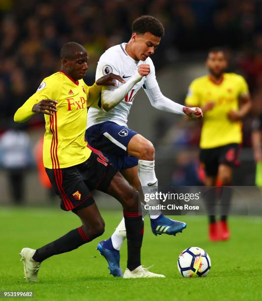 Abdoulaye Doucoure of Watford puts pressure on Dele Alli of Tottenham Hotspur during the Premier League match between Tottenham Hotspur and Watford...