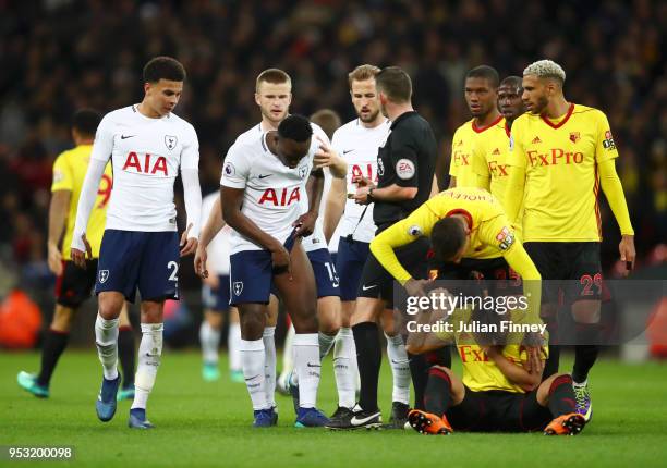 Victor Wanyama of Tottenham Hotspur appeals to the referee following being shown a yellow card, as Jose Holebas of Watford checks if team mate...