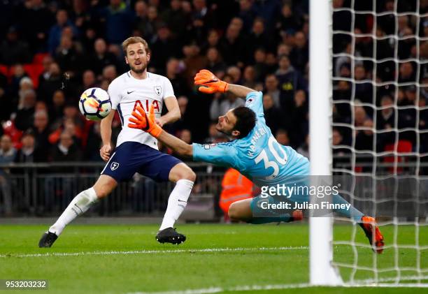 Harry Kane of Tottenham Hotspur shoots and scores past Orestis Karnezis of Watford, a goal that is later disallowed during the Premier League match...