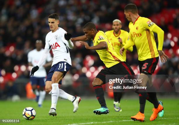 Erik Lamela of Tottenham Hotspur holds off Jose Holebas and Christian Kabasele of Watford during the Premier League match between Tottenham Hotspur...