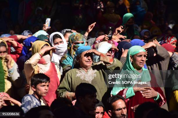 Kashmiri women mourns while watching the Funeral procession of Shahid Ahmed at his residence Arihal Village in south Kashmir's Pulwama District on...