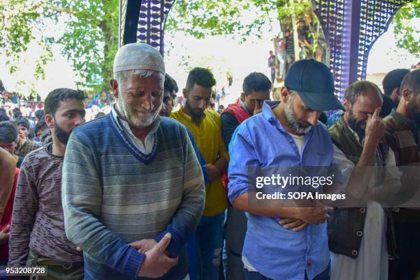 Kashmiri Muslims offering funeral prayers during Funeral of Shahid Ahmed at his residence Arihal Village in south Kashmir's Pulwama District on...