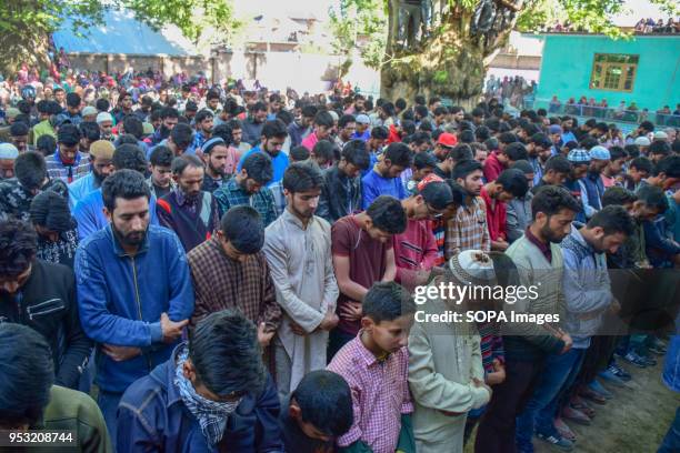 Kashmiri Muslims offering funeral prayers during Funeral of Shahid Ahmed at his residence Arihal Village in south Kashmir's Pulwama District on...