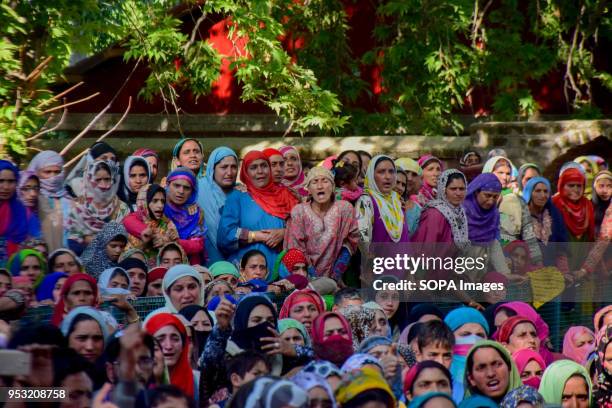 Kashmiri women mourns while watching the Funeral procession of Shahid Ahmed at his residence Arihal Village in south Kashmir's Pulwama District on...