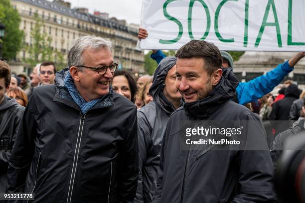 Leader of the French Communist Party Pierre Laurent and French anti-capitalist party NPA leader Olivier Besancenot smile as they take part in a rally...