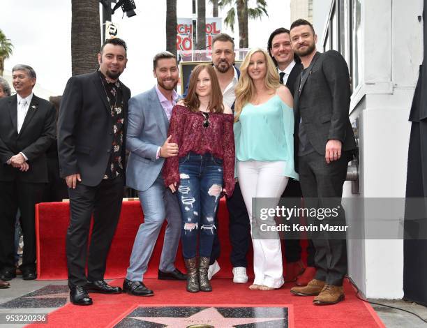 Chris Kirkpatrick, Joey Fatone, Justin Timberlake, JC Chasez and Lance Bass of NSYNC pose with family during the ceremony honoring NSYNC with a star...