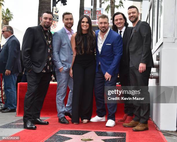 Chris Kirkpatrick, Joey Fatone, Justin Timberlake, JC Chasez and Lance Bass of NSYNC pose with family during the ceremony honoring NSYNC with a star...