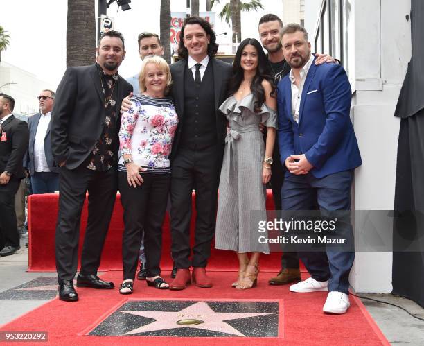 Chris Kirkpatrick, Joey Fatone, Justin Timberlake, JC Chasez and Lance Bass of NSYNC pose with family during the ceremony honoring NSYNC with a star...