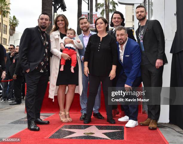 Chris Kirkpatrick, Joey Fatone, Justin Timberlake, JC Chasez and Lance Bass of NSYNC pose with family during the ceremony honoring NSYNC with a star...