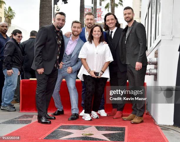 Chris Kirkpatrick, Joey Fatone, Justin Timberlake, JC Chasez and Lance Bass of NSYNC pose with family during the ceremony honoring NSYNC with a star...